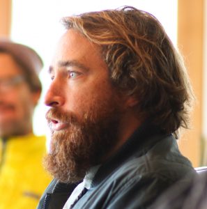 A profile image of Trey Highton looking to the left with beard and mid-length blonde hair