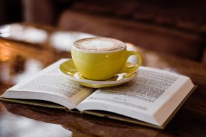 yellow coffee mug on book