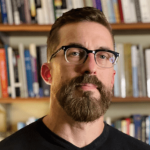 Prof. Mathiowetz in front of books