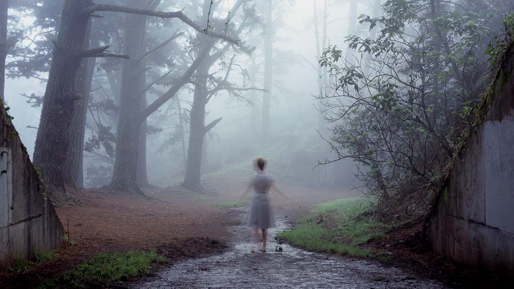 Woman standing in forest